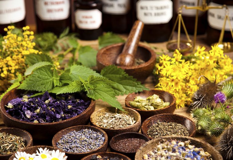 Bowls of flowers and herbs with mortar and pestle