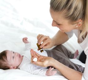 Mom giving baby homeopathic remedy